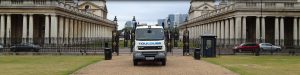 plant hire truck next to large pillared buildings